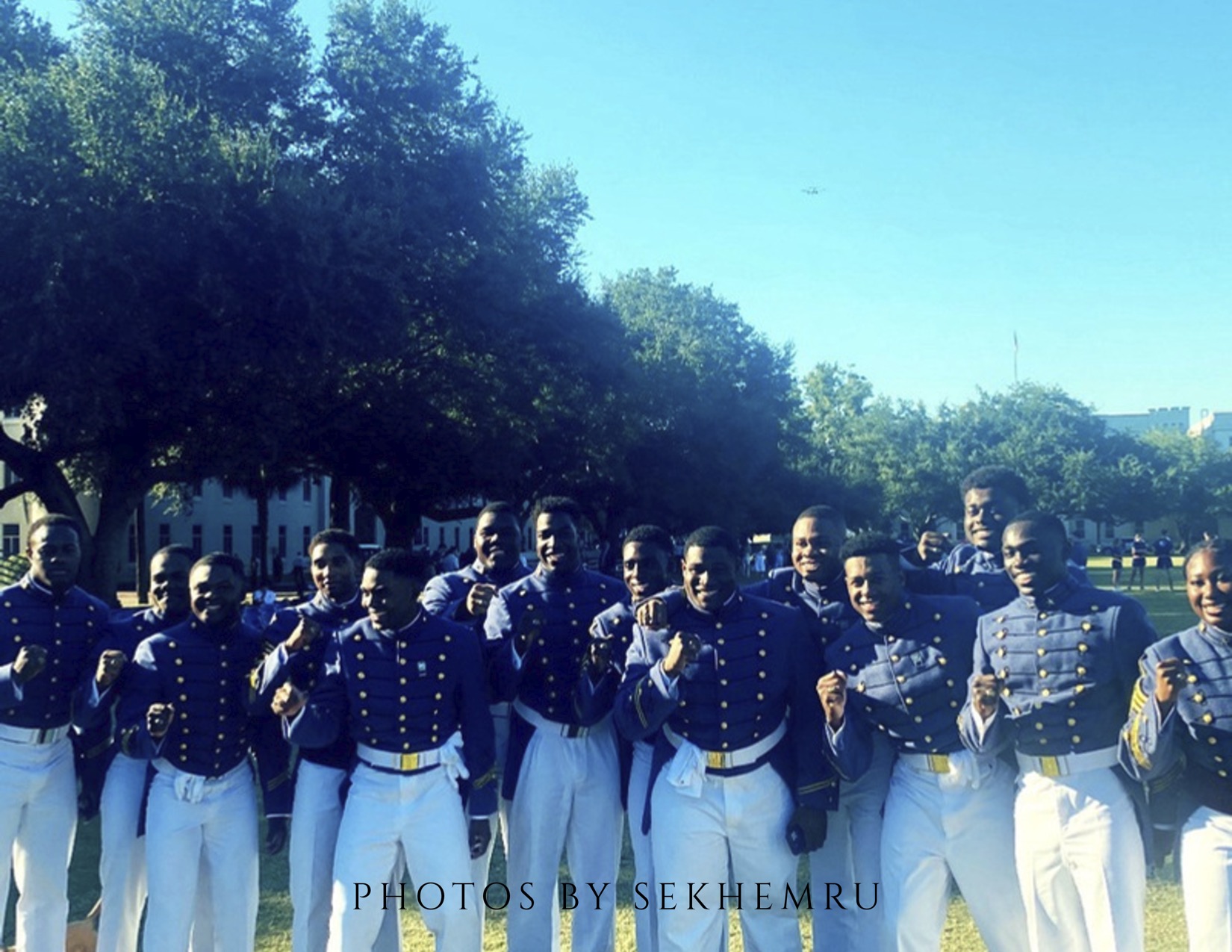 Group portrait in dress uniforms with raised fists